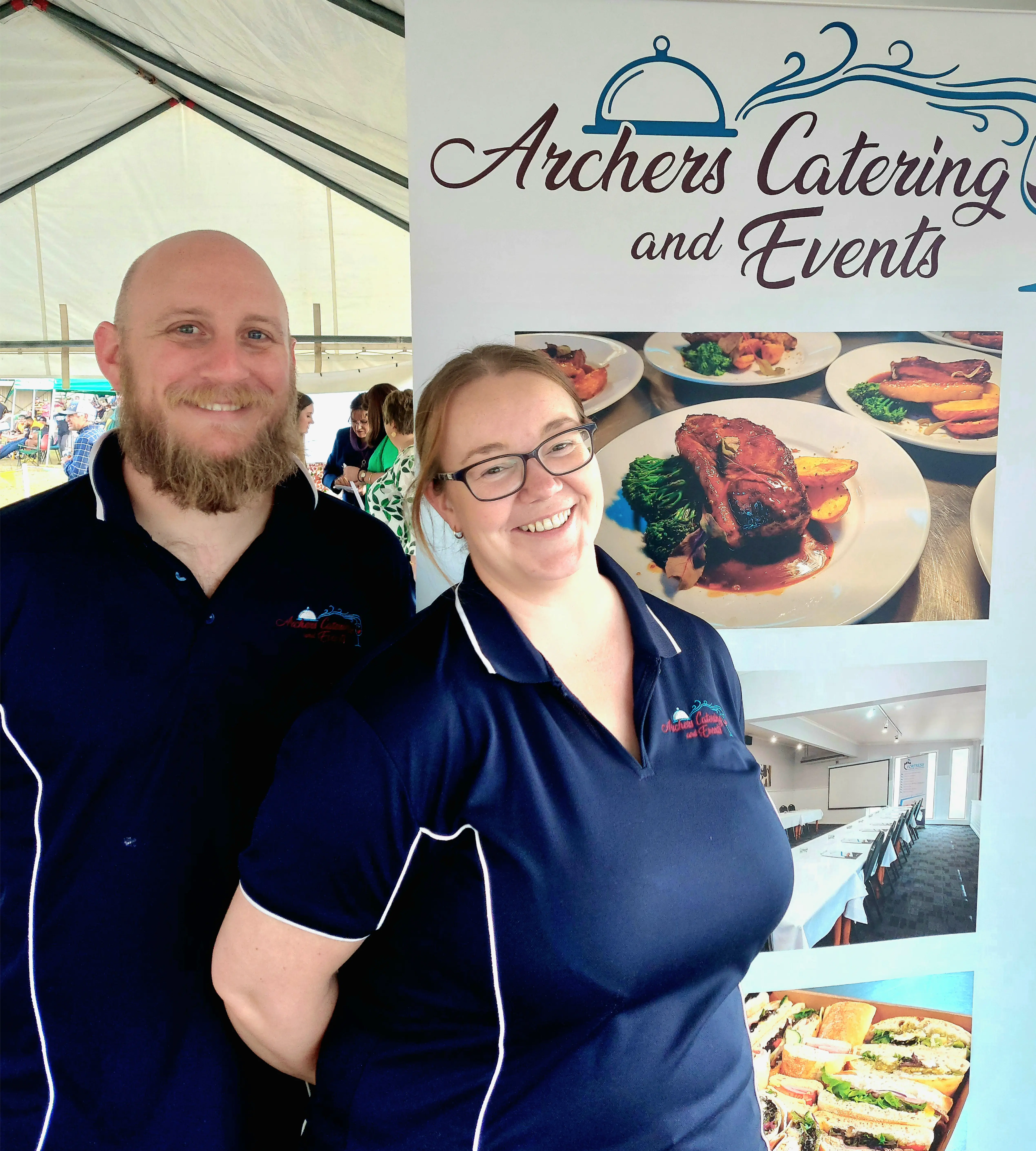 Adam and Jemma Archer at a market event standing in front of the Archers Catering and Events banner